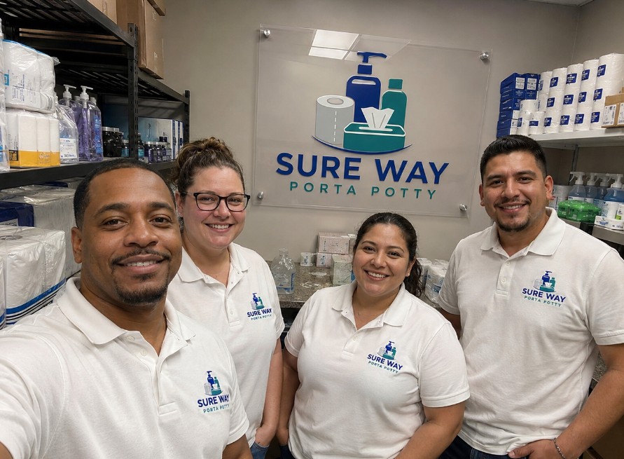 The Sure Way Porta Potty team in branded polos at their Holland, Michigan base